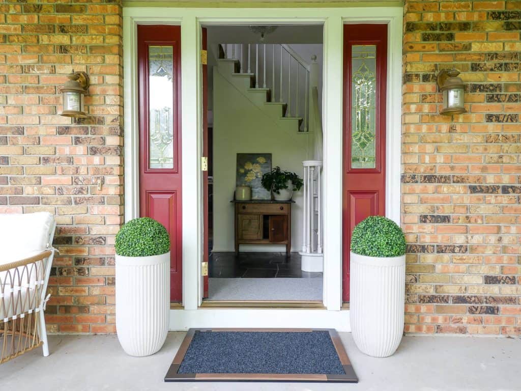 Porte + Hall doormats at the front door of a home.