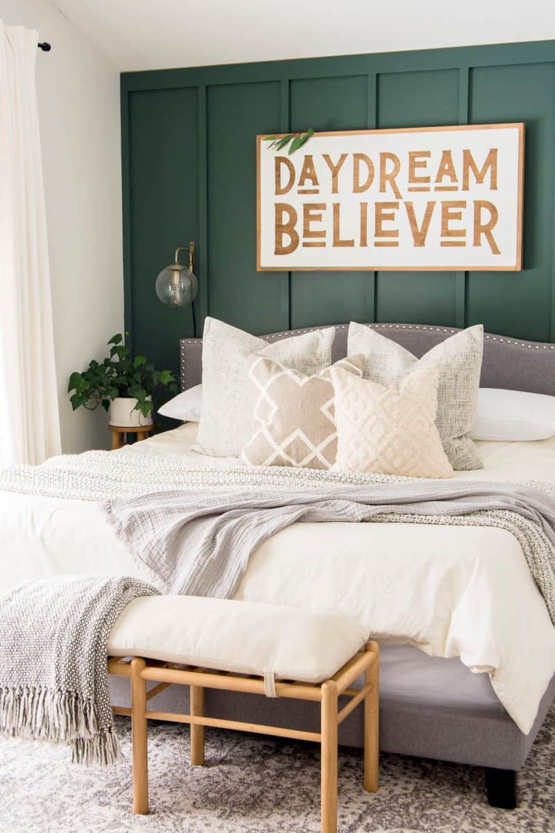 Dark green accent wall in a bedroom.