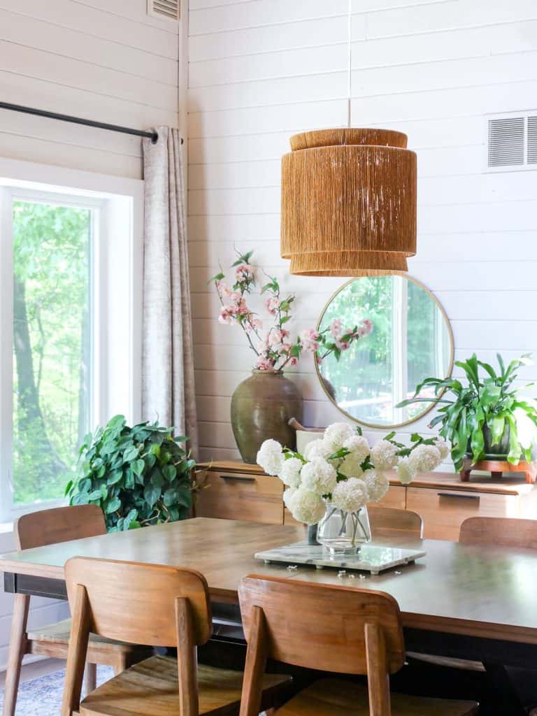 White shiplap walls in a dining room.