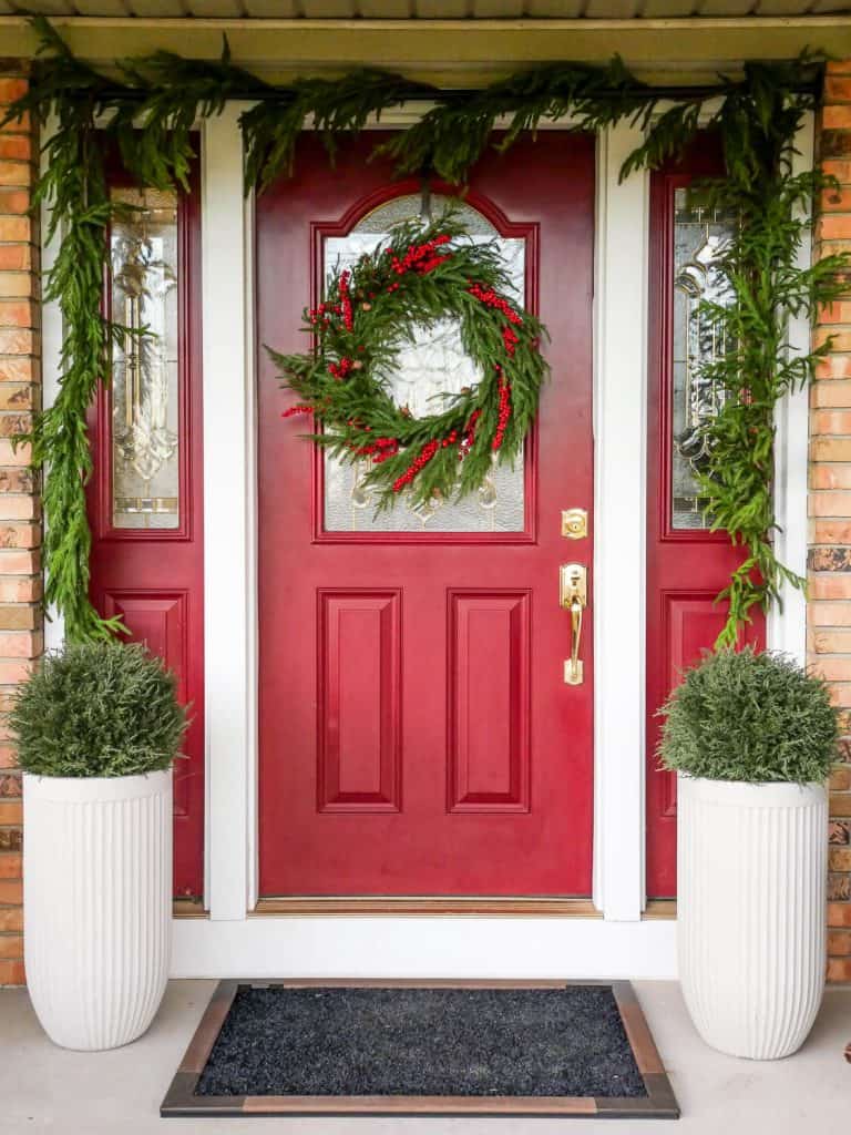 Winter porch decor with evergreens.