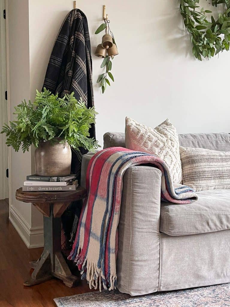 Cozy blanket draped over a sofa arm.