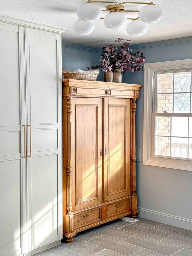 Semi flush mount light in a mudroom with cabinets.