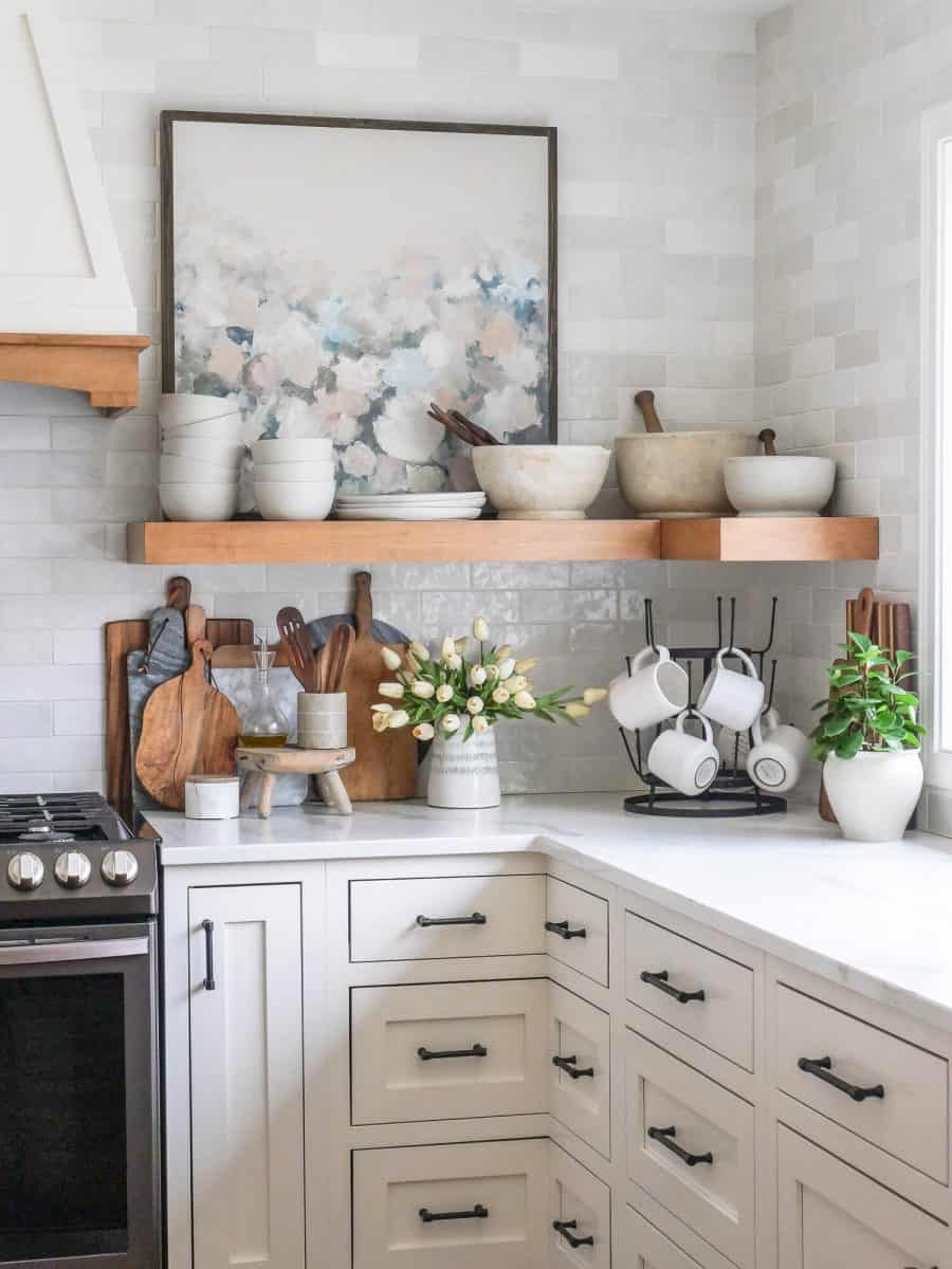 Open shelving in a kitchen with tile backsplash.
