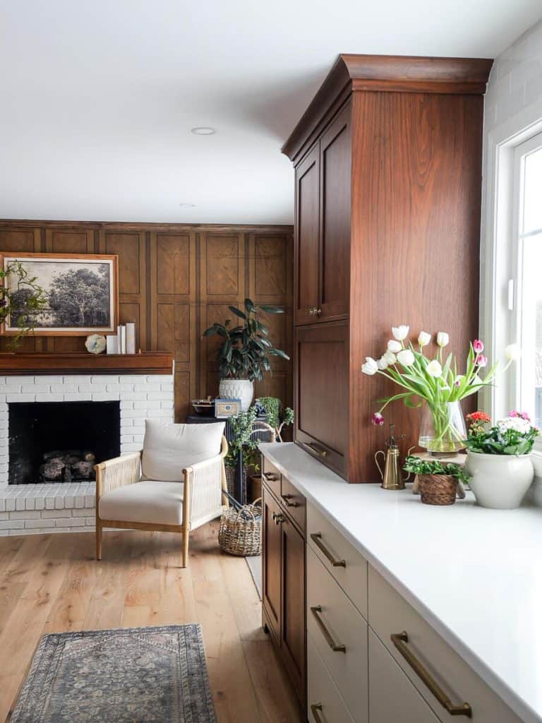 Walnut appliance hutch in a kitchen with brick fireplace.