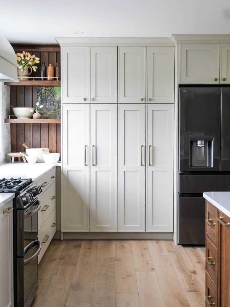 Traditional kitchen cabinets with a refrigerator.