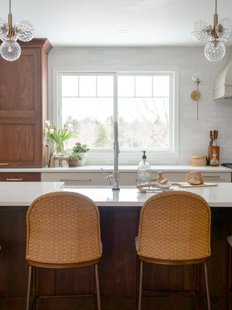 Windows in a kitchen with sink in island.
