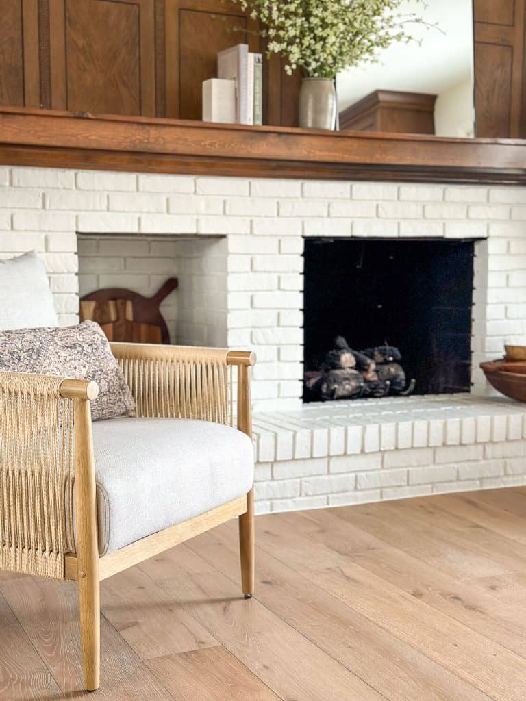 Brick fireplace painted with seating area.