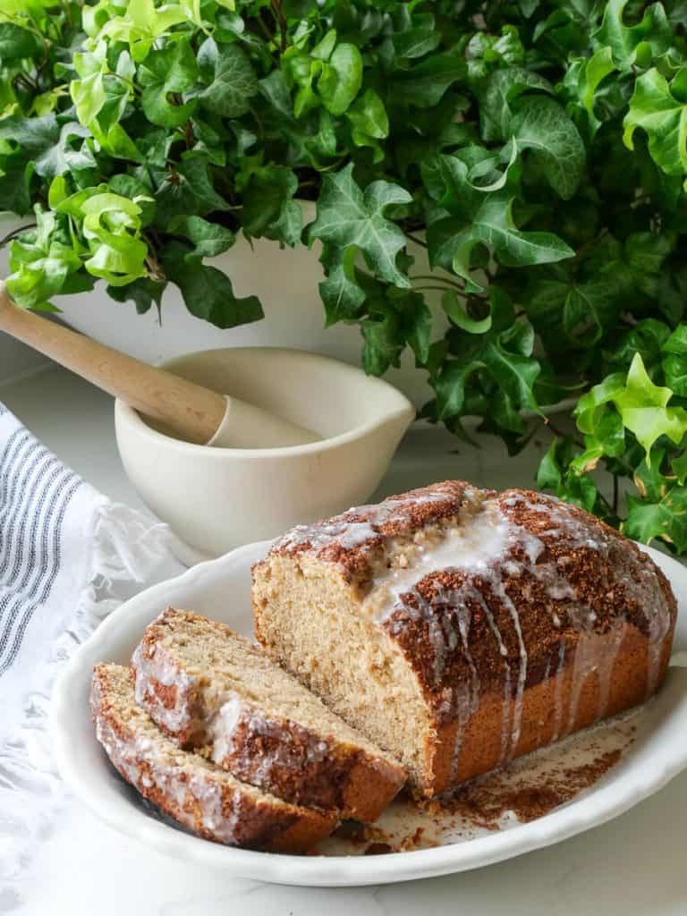 Loaf of bread on a counter next to mortar and pestle.