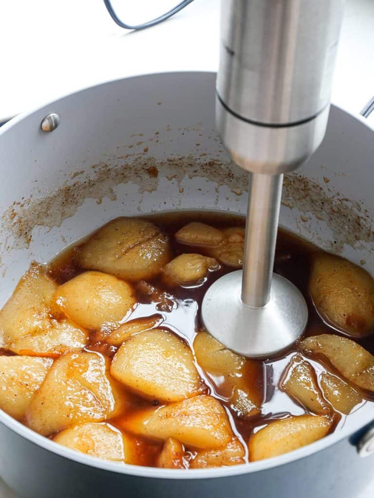 Using an immersion blender on stewed pears.