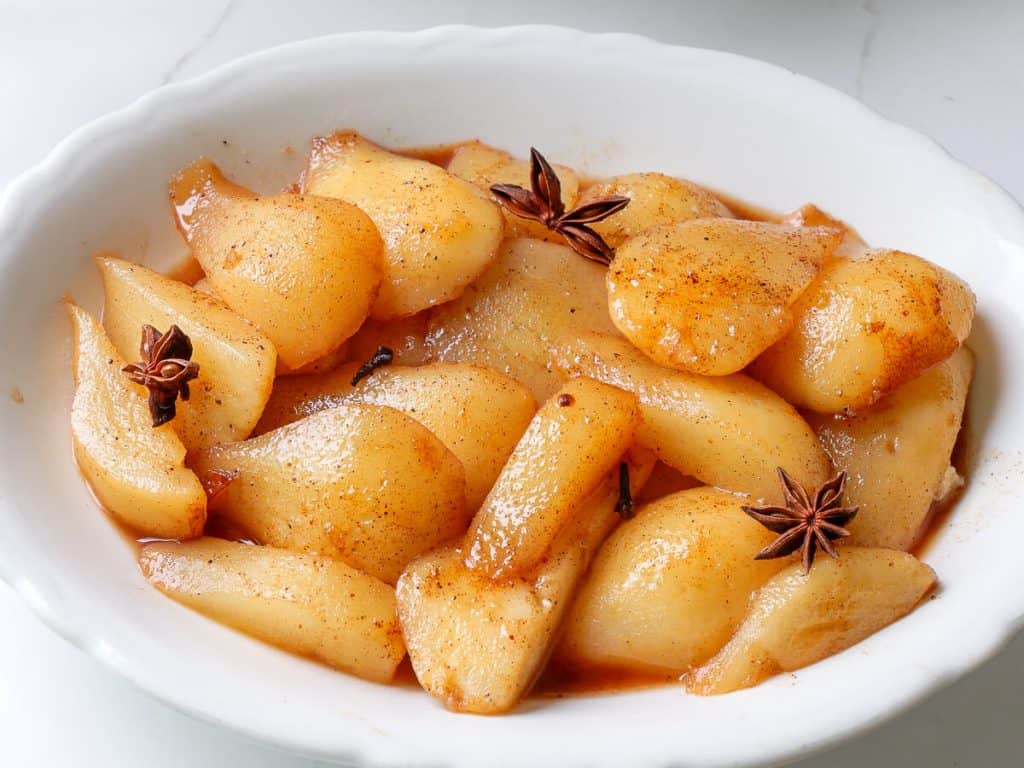 Sliced stewed pears on a plate.