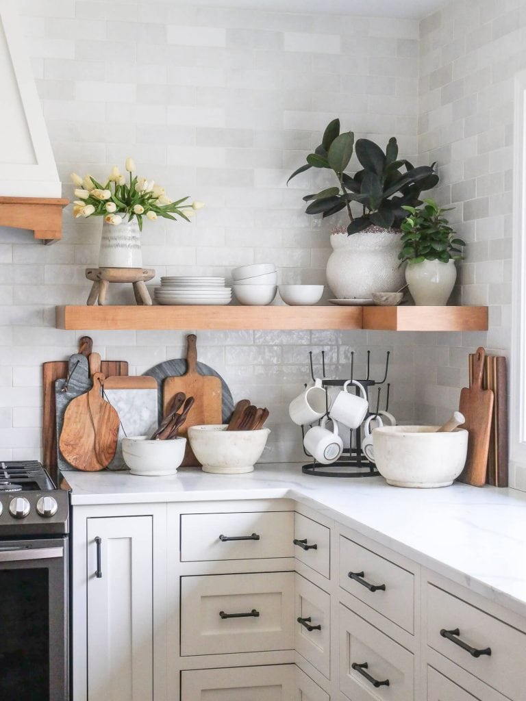 Everyday dishes on a corner kitchen shelf.