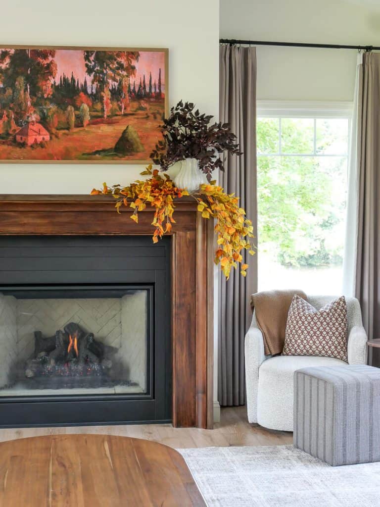 Fall foliage on a living room mantel decorated for fall.