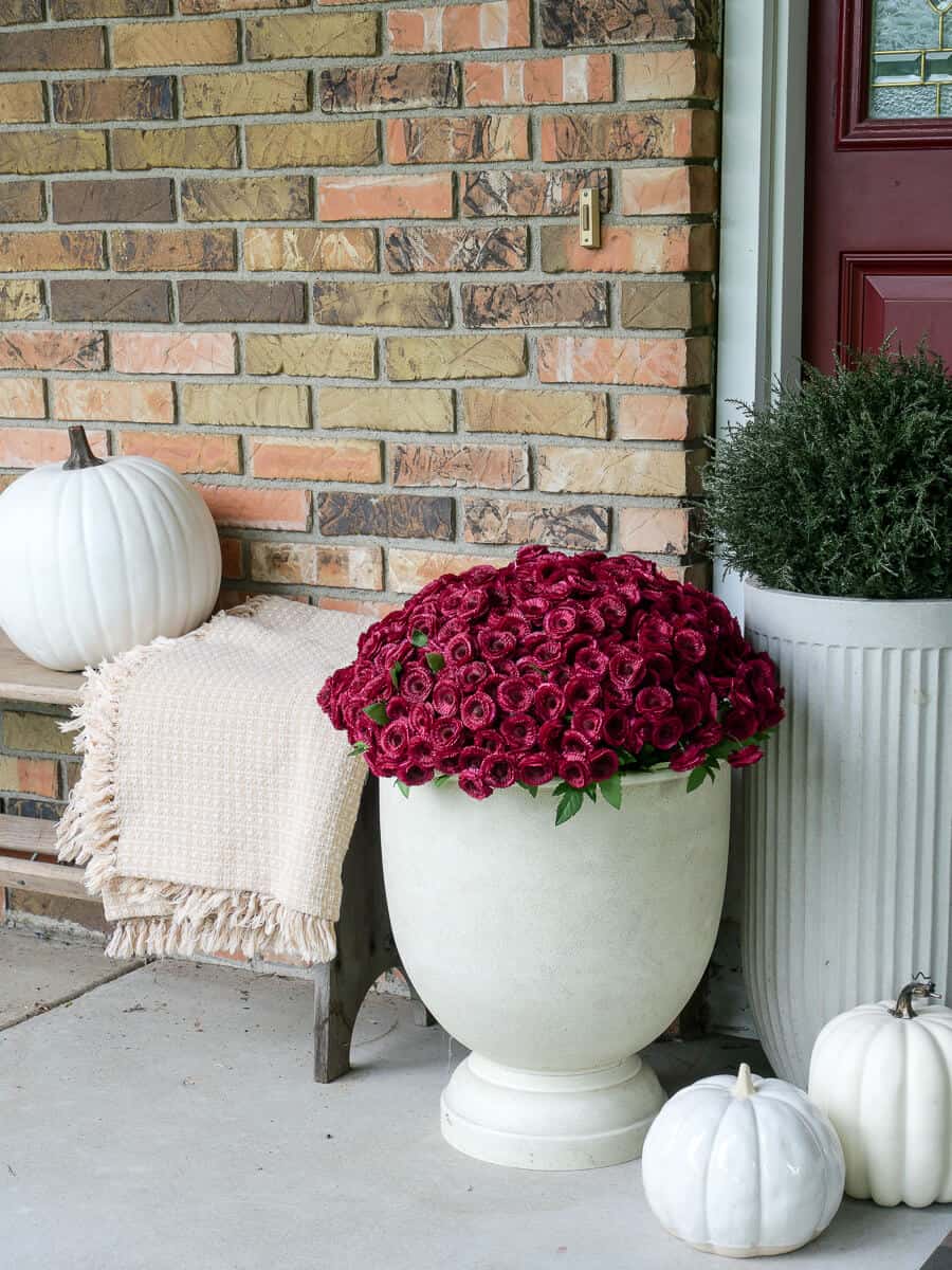 Faux mums on a front porch.