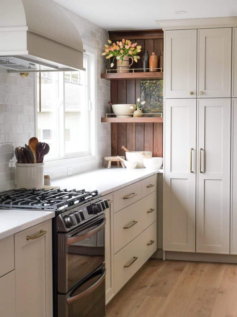 Kitchen shelves with wood paneling.