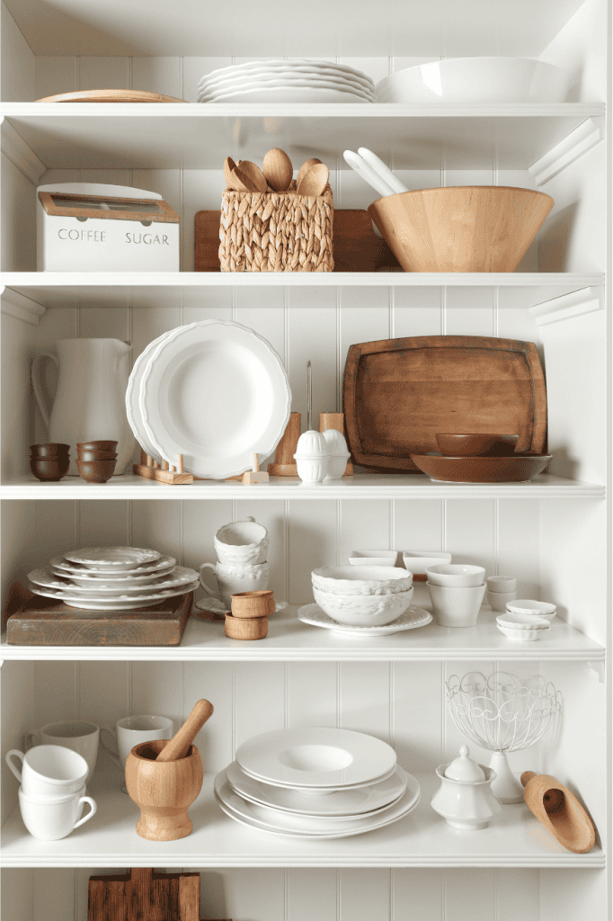 Pretty serving ware on kitchen shelves.