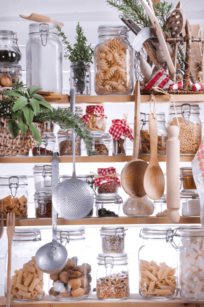 Kitchen shelves in front of a window.