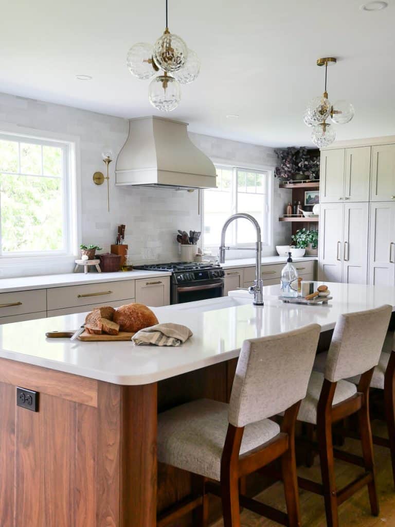 Kitchen island with range hood in background.