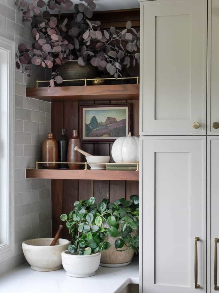 Fall decor on kitchen shelves.