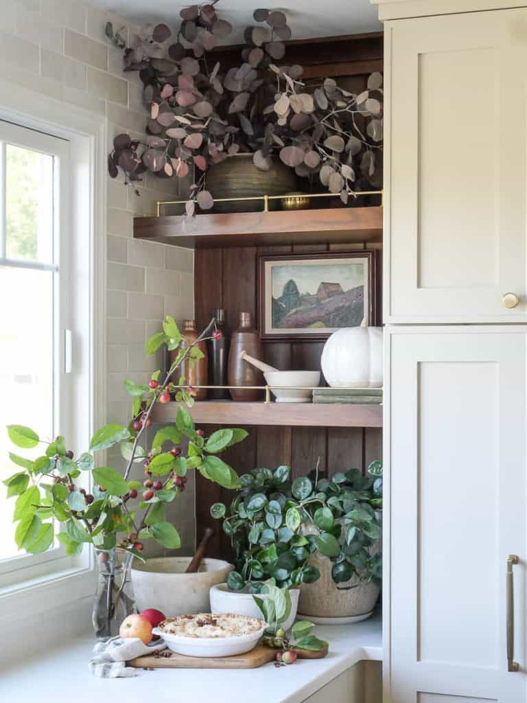 Kitchen corner cabinets with pie on countertop.