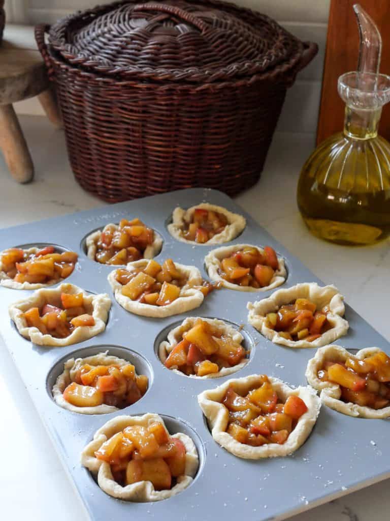 Apple filling in muffin pans.