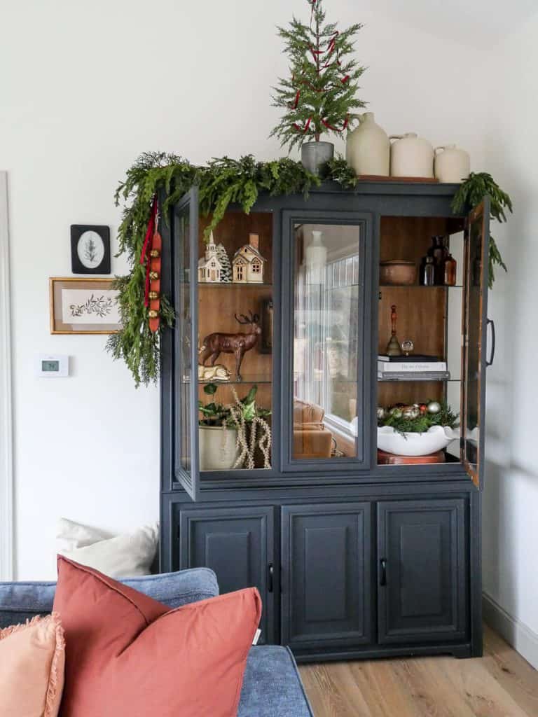 Black cabinet decorated for Christmas.