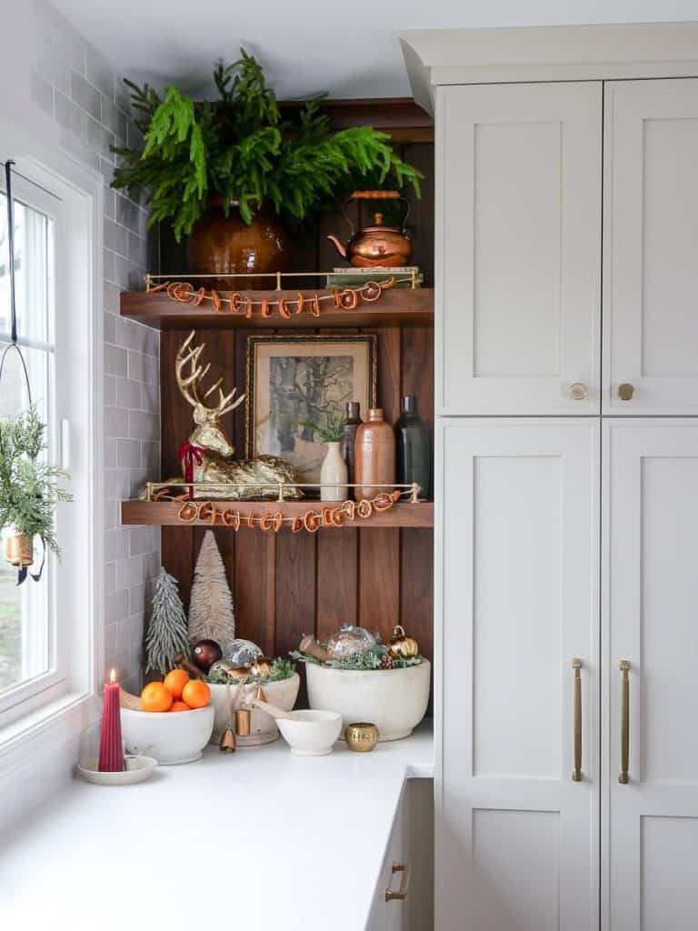 Dried orange slices on kitchen shelves as budget Christmas decor.