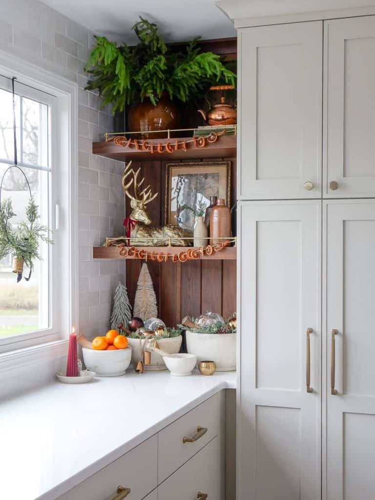 Simple christmas decorations on a kitchen shelf.