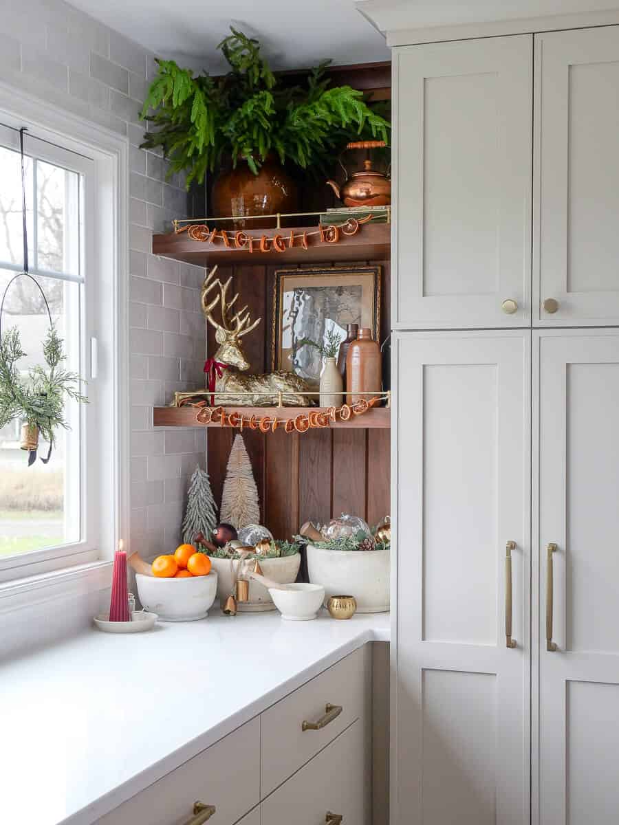 Simple christmas decorations on a kitchen shelf.