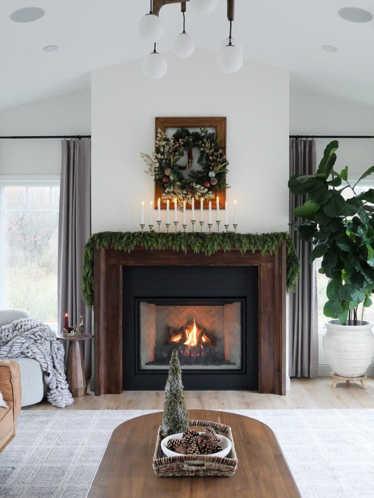 Christmas wreath hanging above a fireplace.