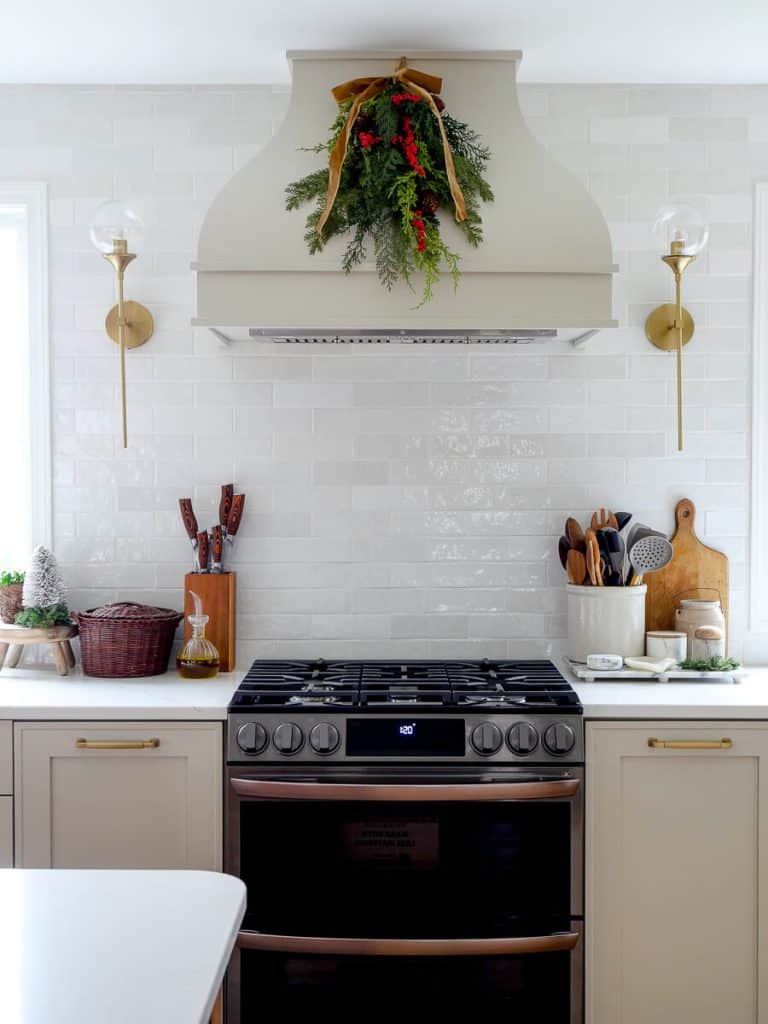 A Christmas swag on the kitchen range hood.