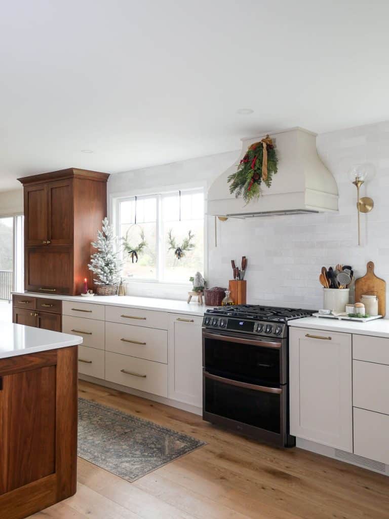 Christmas wreaths in kitchen windows.