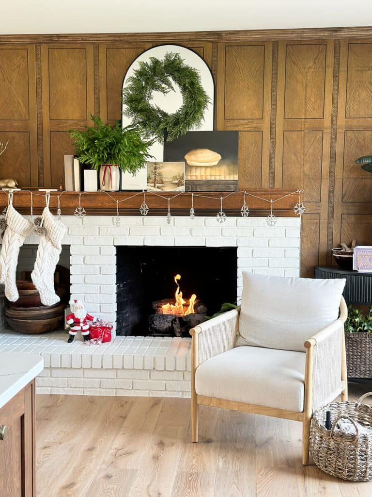 Santa by a fireplace.