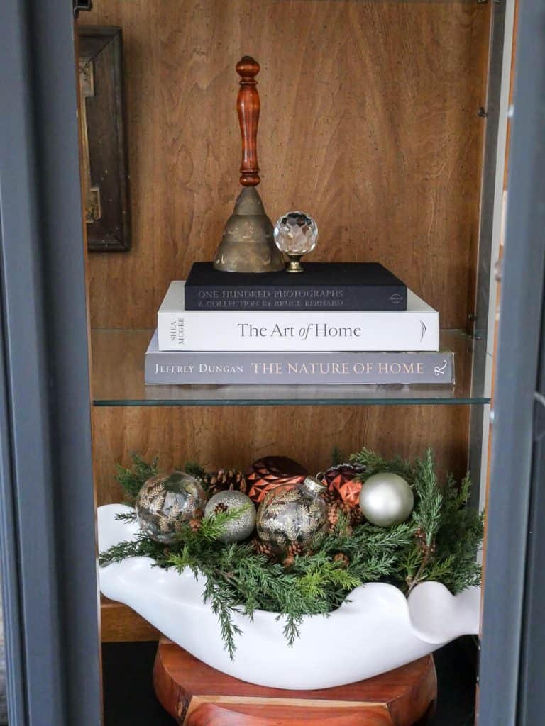 Bowl of ornaments in a cabinet.