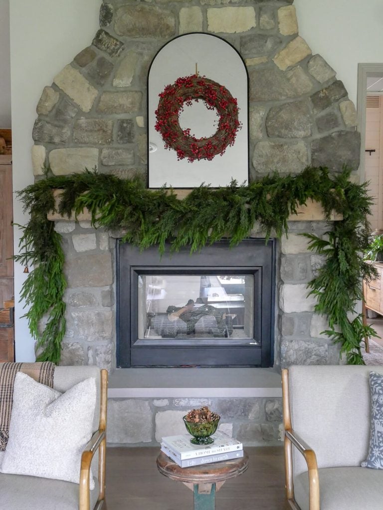 Simple fireplace Christmas mantel on stone fireplace.