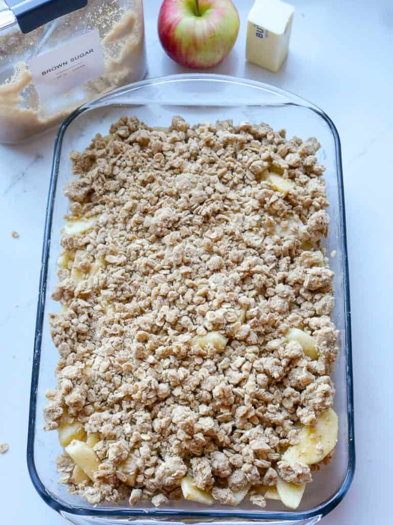 Uncooked apple crisp with crumble topping.