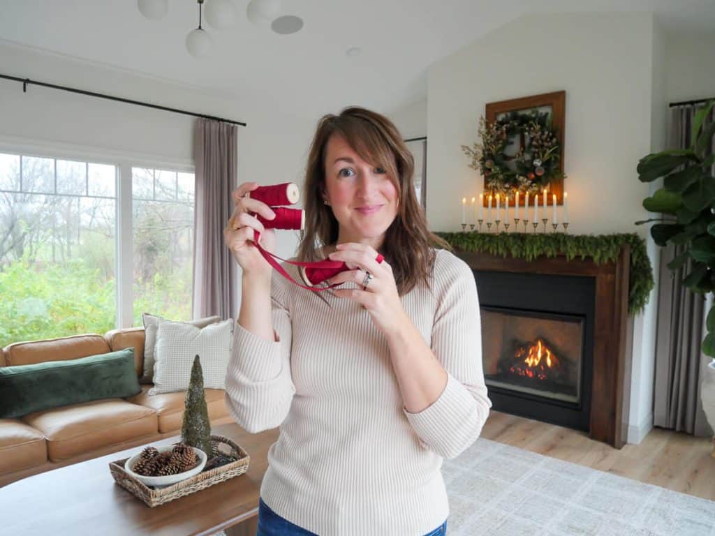 Woman holding a red ribbon.