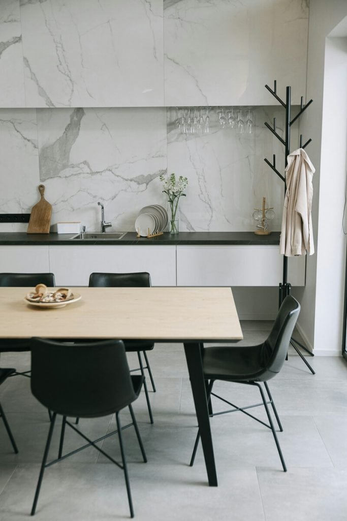 Black countertops in a white kitchen.