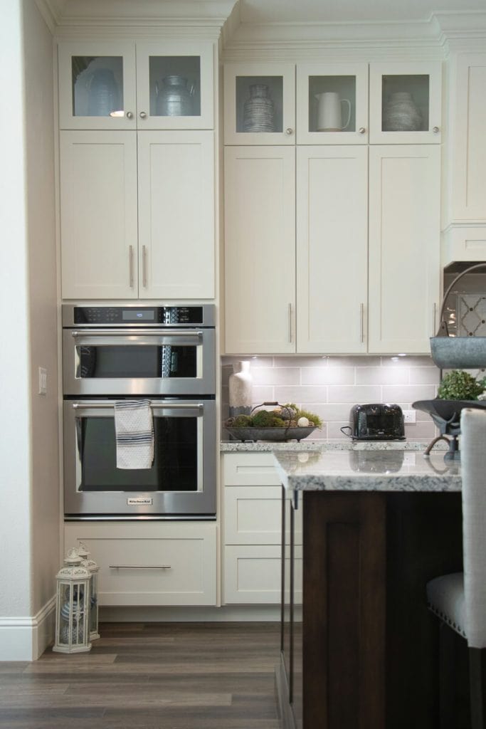 White kitchen with quartz counters.