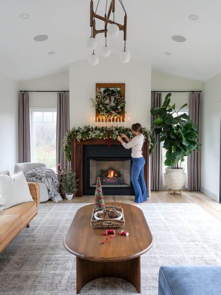 Bowl of pinecones in a living room decorated for Christmas.