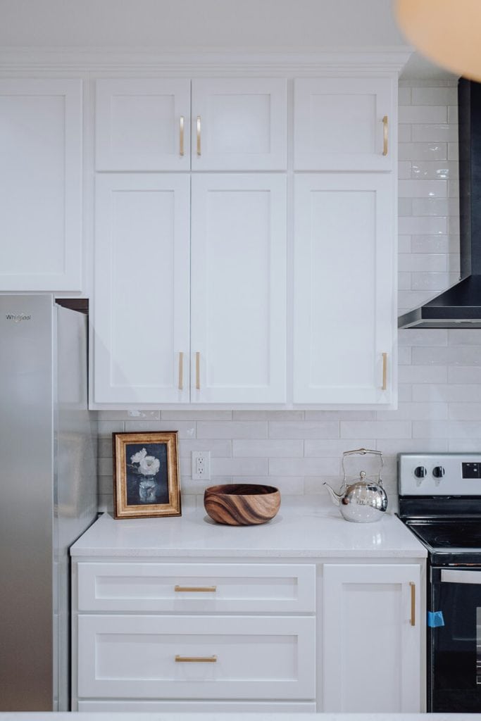 White countertops with white kitchen cabinets.