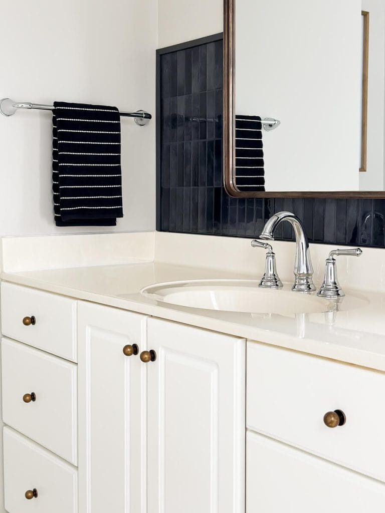 Bathroom backsplash tile with vanity and faucet.