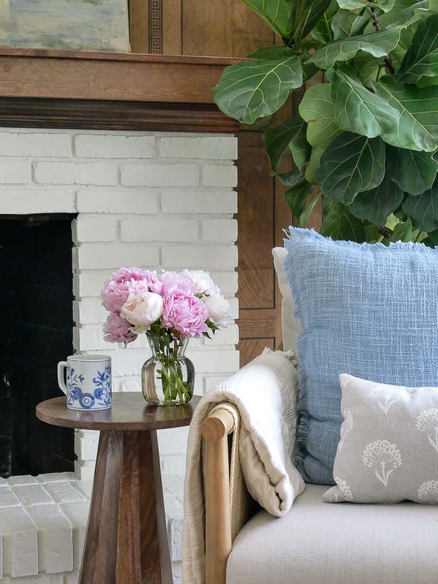 how to make your home cozy - peony bouquet by a fireplace