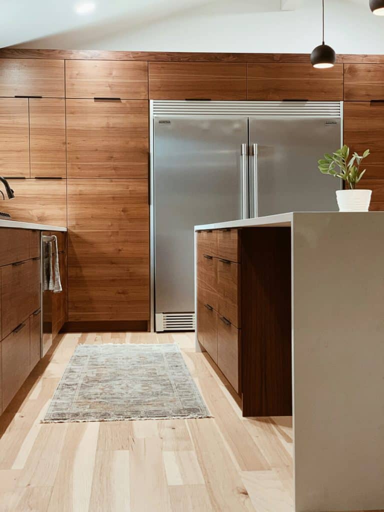 Medium tone wood cabinets in a modern kitchen.