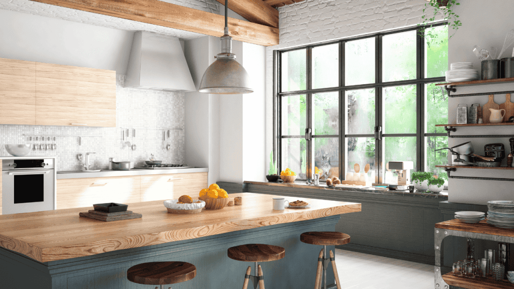 Light green island in a kitchen with large picture window.