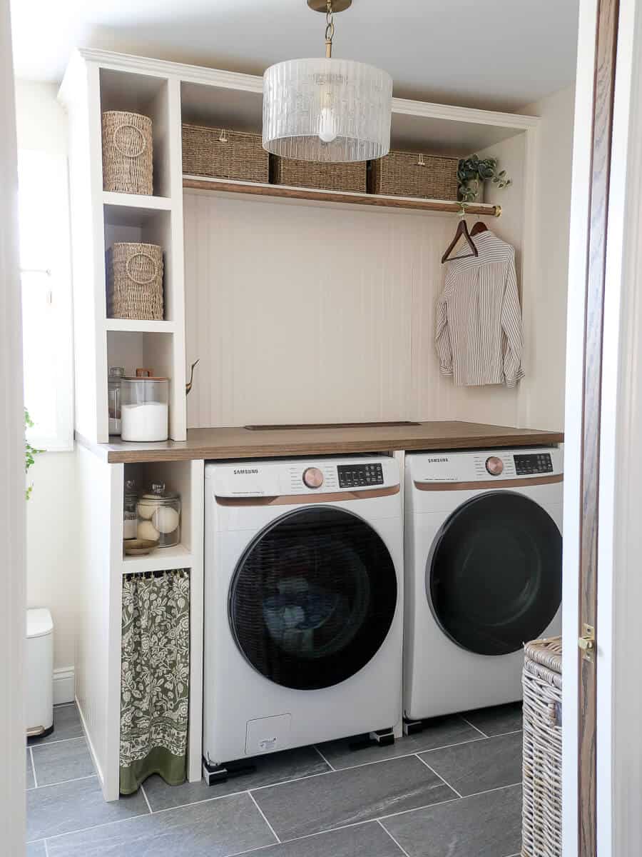 Custom laundry room cabinet with hanging bar.