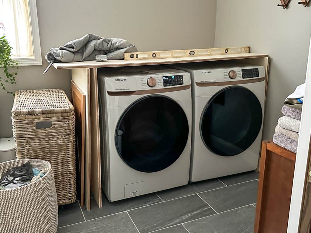 Cut wood for custom laundry room cabinets.