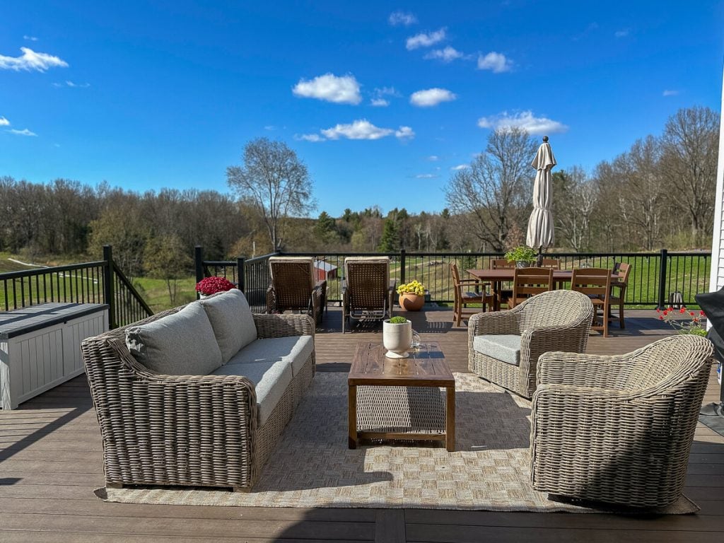 Large deck with patio furniture and an outdoor dining table.