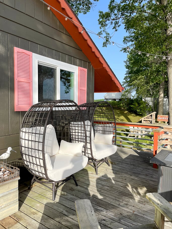 Egg chairs on a deck.