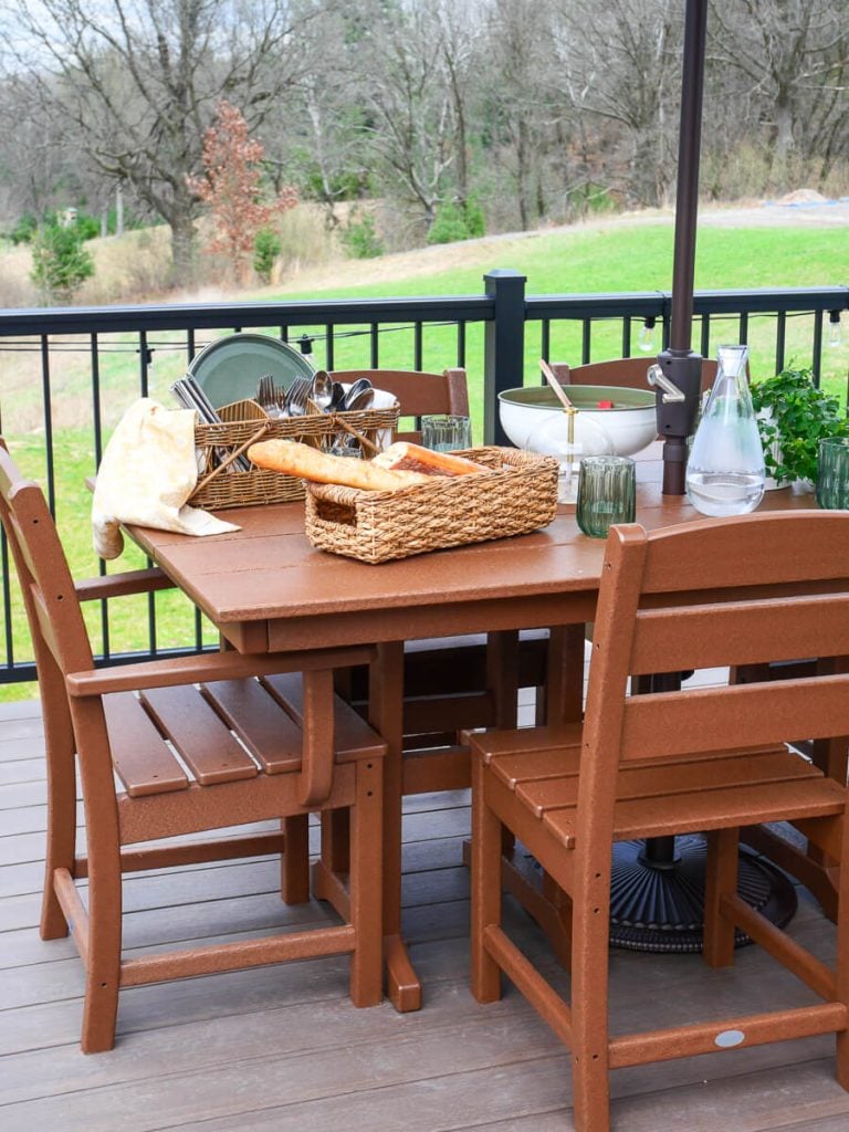 Polywood dining table on a deck.