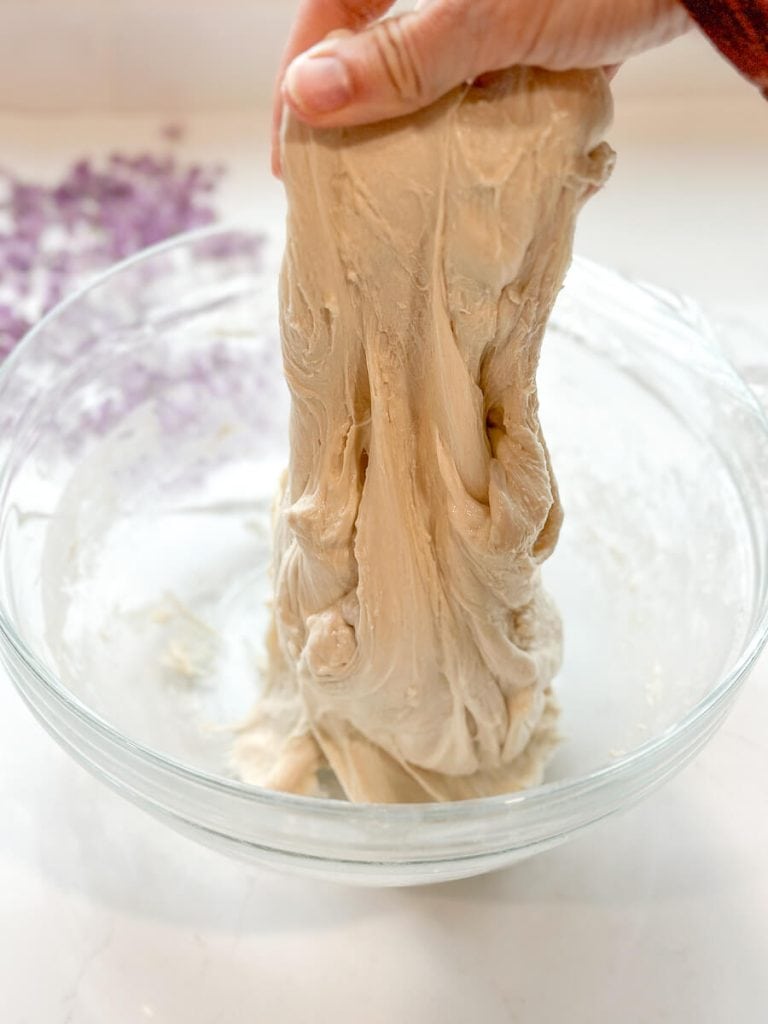 Stretching sourdough dough for stretch and fold instructions.